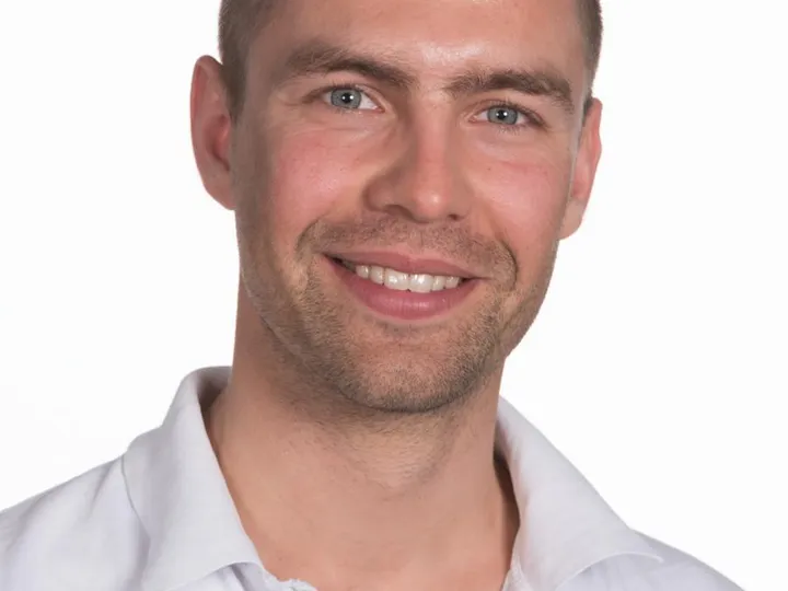 Image of Greg Nowak wearing a white shirt.