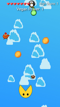 Vegan Power running in a browser tab on a phone-shaped screen: seven full hearts and the score line "Vegan Power: 1" across the top, a blue sky of cartoon clouds with two oranges and a pear falling through it, a chicken, a dog and a penguin drifting down among them, and the round yellow player waiting with its mouth open at the bottom of the play column.